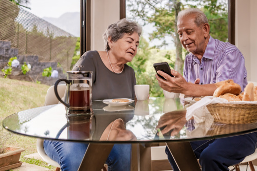 Elderly Couple Looking At Phone