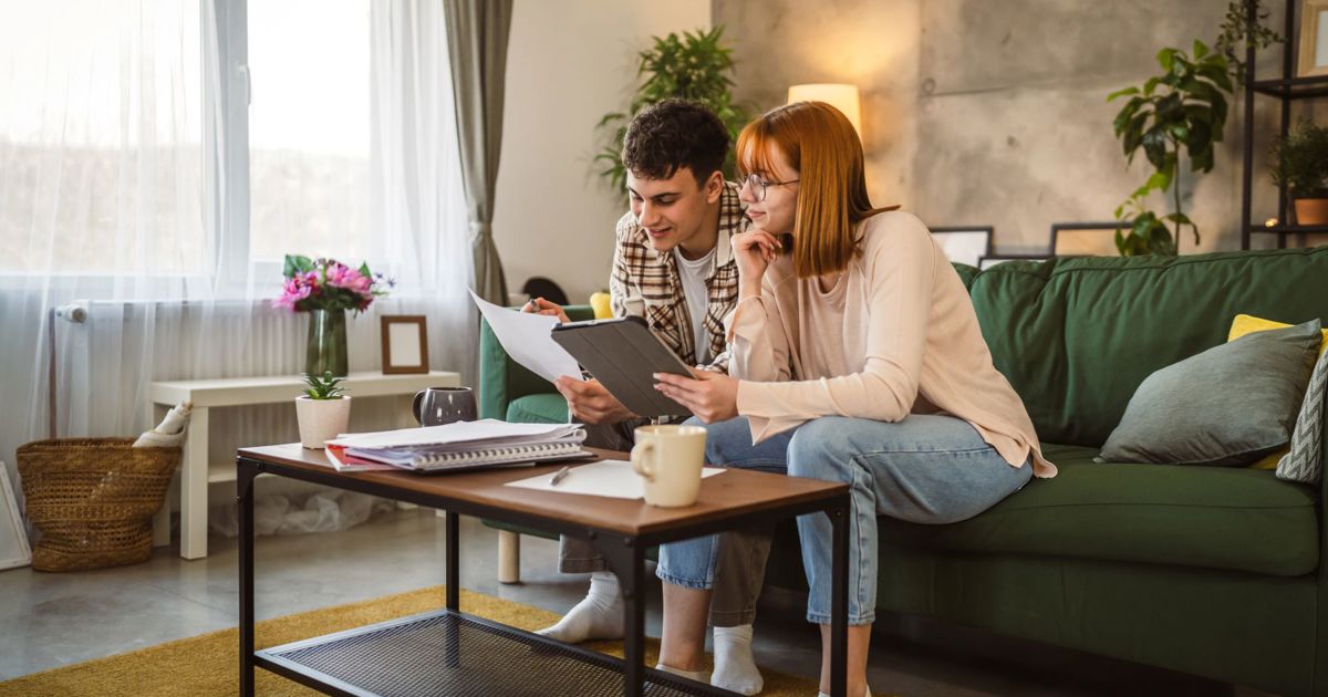 Young couple sorting finances stock