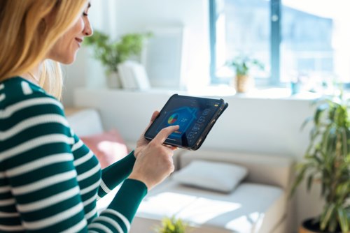 Woman Looking At Tablet Heating Control stock