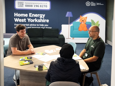 People sat talking at the Home Energy West Yorkshire pop-up shop in Bradford Interchange