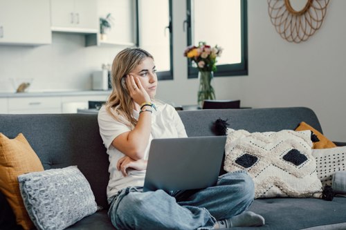 Concerned Woman Sat On Sofa