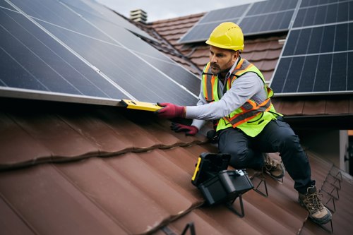Man On Roof Fitting Solar Panels