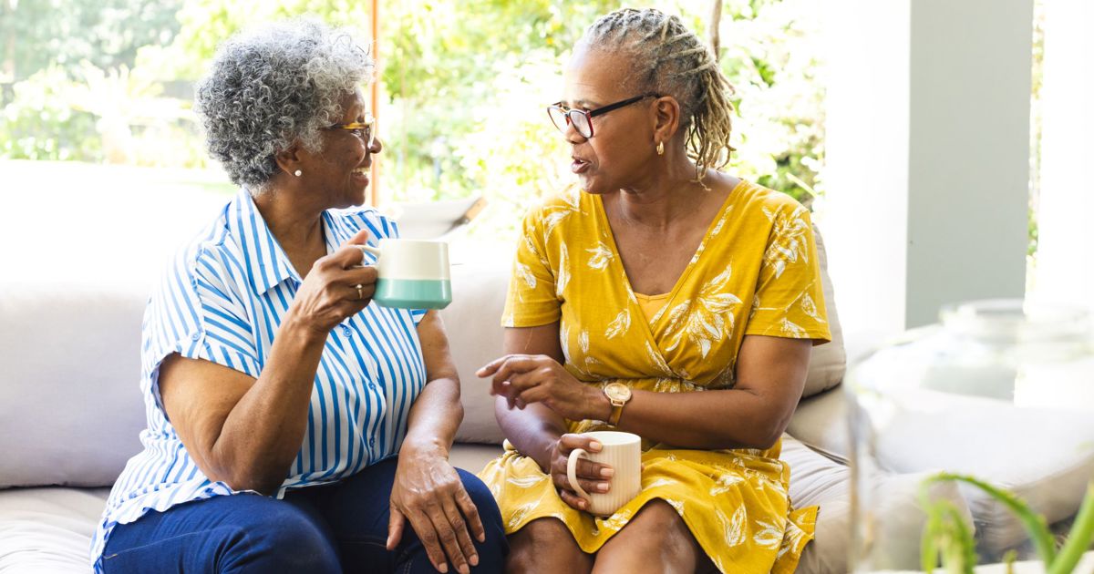 Elderly ladies chatting having a coffee stock